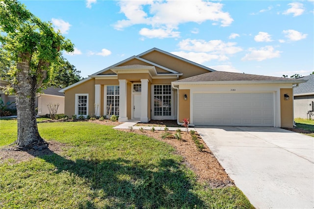 view of front of house with a front lawn, concrete driveway, an attached garage, and stucco siding