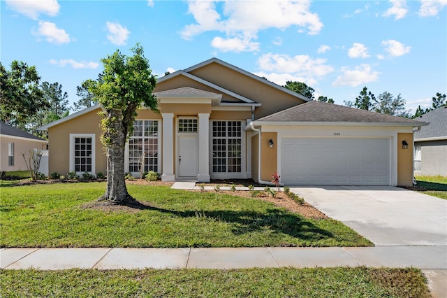 ranch-style home featuring stucco siding, a front lawn, an attached garage, and driveway