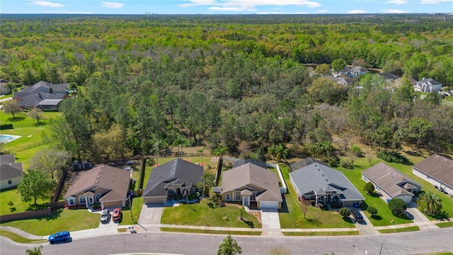 drone / aerial view featuring a view of trees and a residential view