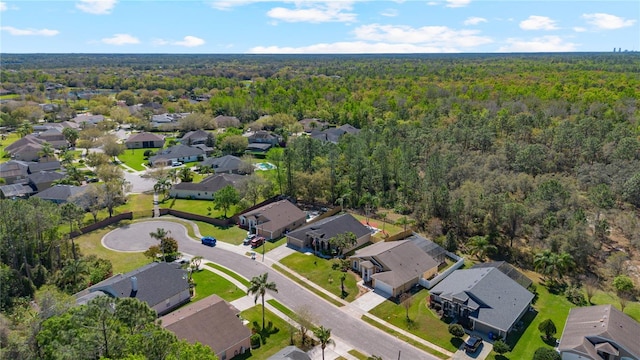 birds eye view of property with a wooded view and a residential view