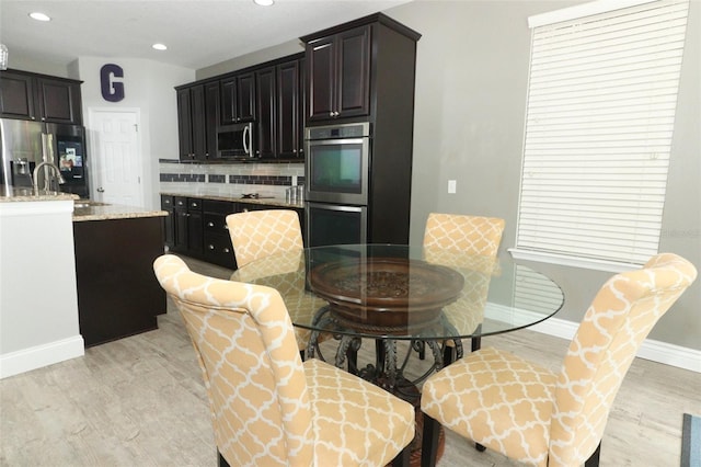 dining area featuring recessed lighting, baseboards, and light wood-style flooring