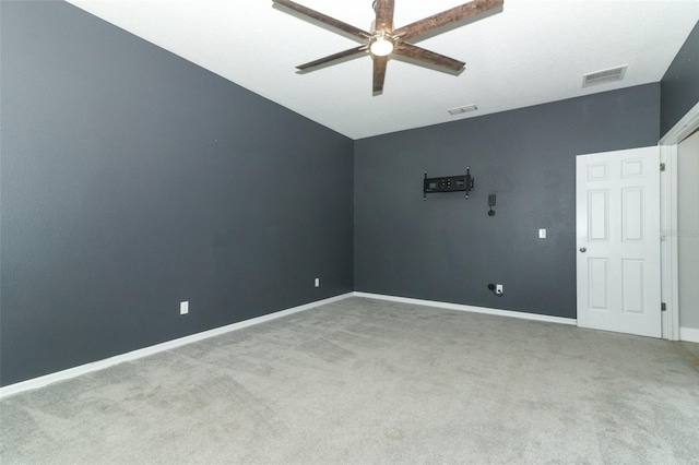 spare room featuring visible vents, carpet floors, baseboards, and a ceiling fan