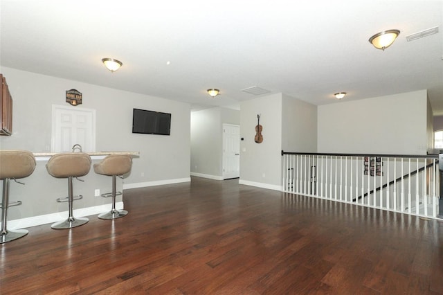 unfurnished room with visible vents, baseboards, and wood finished floors