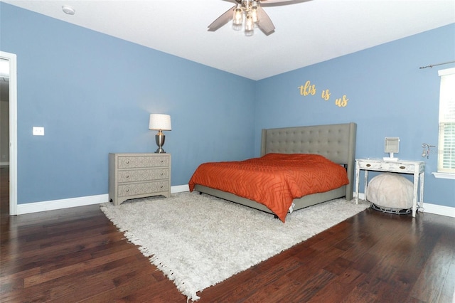 bedroom with a ceiling fan, baseboards, and wood finished floors