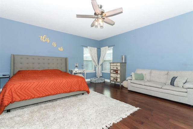 bedroom featuring ceiling fan, baseboards, and wood finished floors