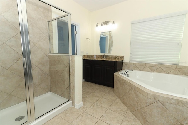 bathroom with tile patterned floors, a garden tub, a stall shower, and vanity