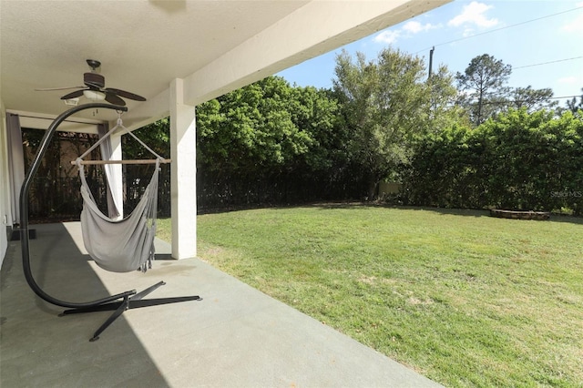 view of yard with a patio, ceiling fan, and fence