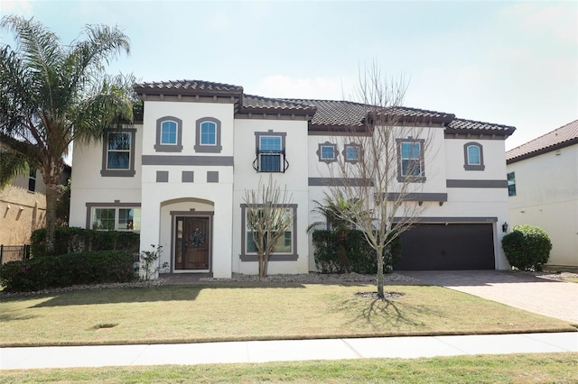 mediterranean / spanish house with stucco siding, driveway, and a garage