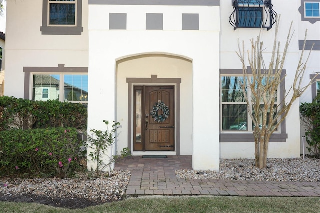 doorway to property with stucco siding