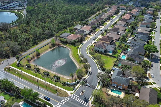 birds eye view of property featuring a water view and a residential view