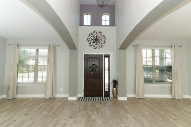 2351 Kelbrook Ct, Oviedo, FL 32765 - entrance foyer featuring wood finished floors, plenty of natural light, arched walkways, and baseboards