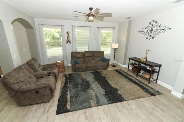 2351 Kelbrook Ct, Oviedo, FL 32765 - living area with arched walkways, wood finished floors, healthy amount of natural light, and ceiling fan