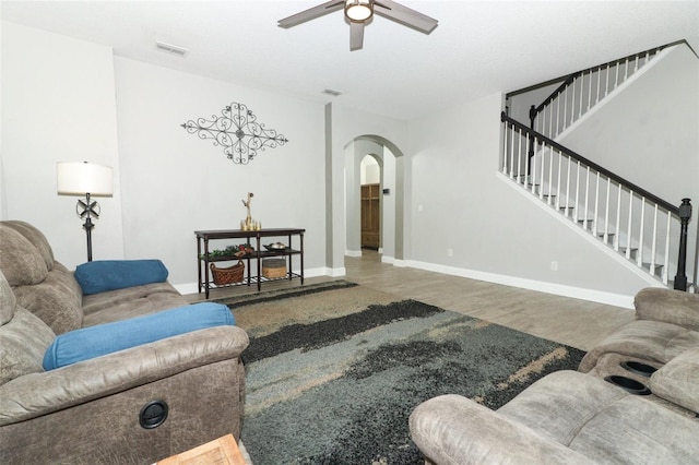 2351 Kelbrook Ct, Oviedo, FL 32765 - living area with ceiling fan, arched walkways, wood finished floors, stairs, and baseboards