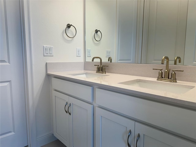 bathroom featuring a sink and double vanity