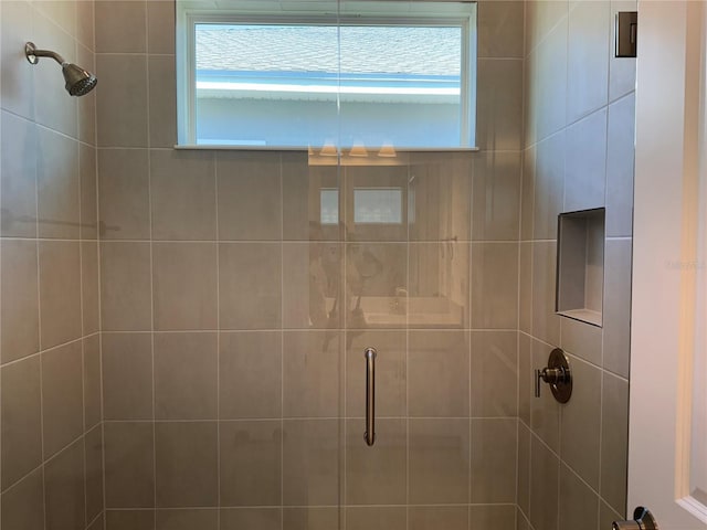 full bath featuring a shower stall and plenty of natural light