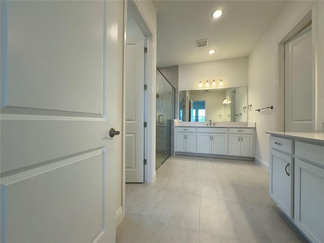 bathroom with visible vents, baseboards, recessed lighting, a stall shower, and vanity