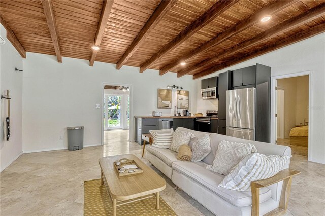 living room with wooden ceiling, baseboards, and beam ceiling