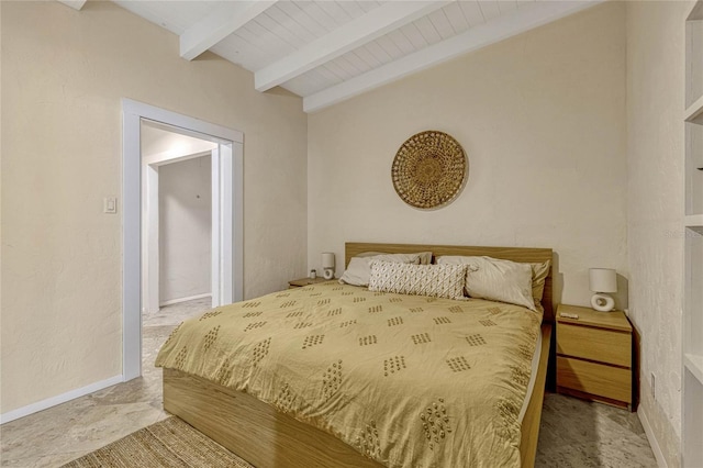 bedroom featuring vaulted ceiling with beams and baseboards