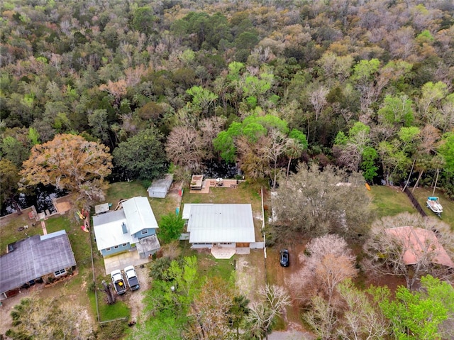 drone / aerial view with a wooded view