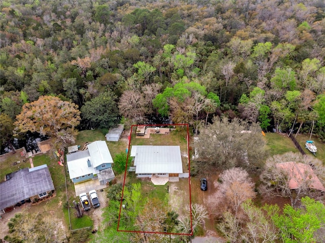 birds eye view of property featuring a view of trees