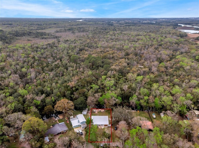 drone / aerial view featuring a wooded view