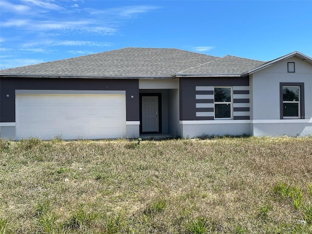 view of front facade with stucco siding, a garage, and a shingled roof