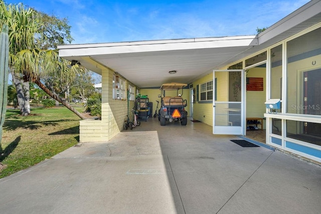 view of parking with an attached carport and driveway