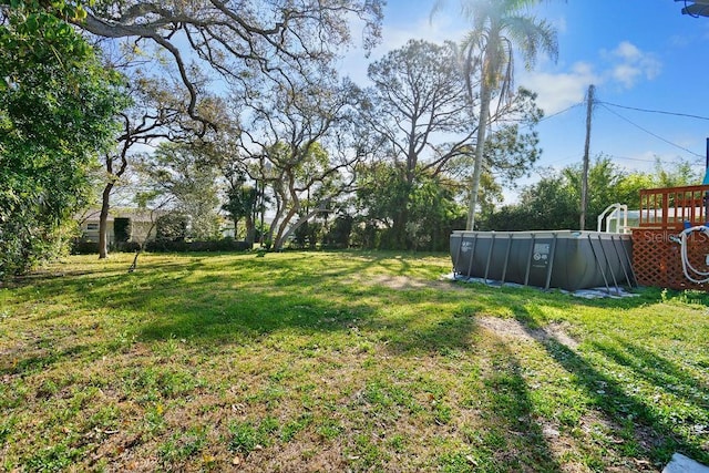 view of yard featuring an outdoor pool