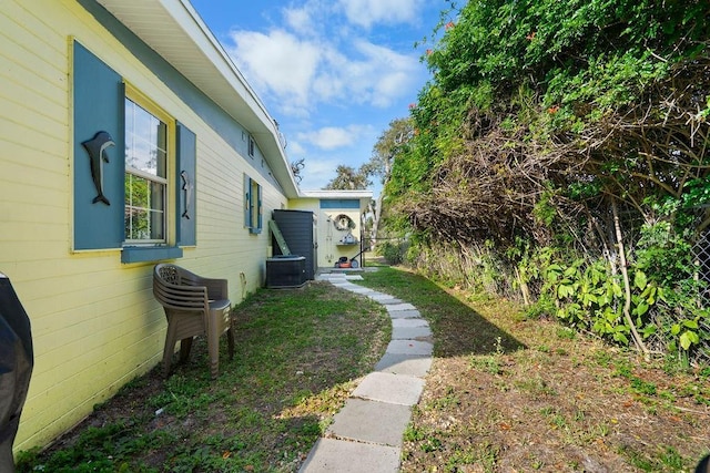 view of yard with cooling unit and fence