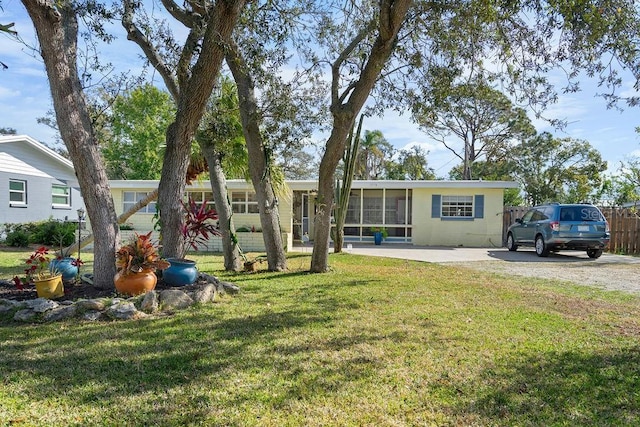 exterior space with a lawn and a sunroom