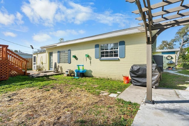 back of house with brick siding and a pergola