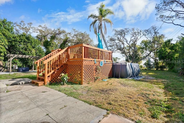 exterior space with a wooden deck, a lawn, and stairs