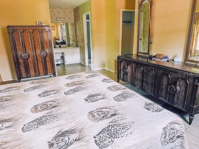 interior space featuring light tile patterned flooring and baseboards