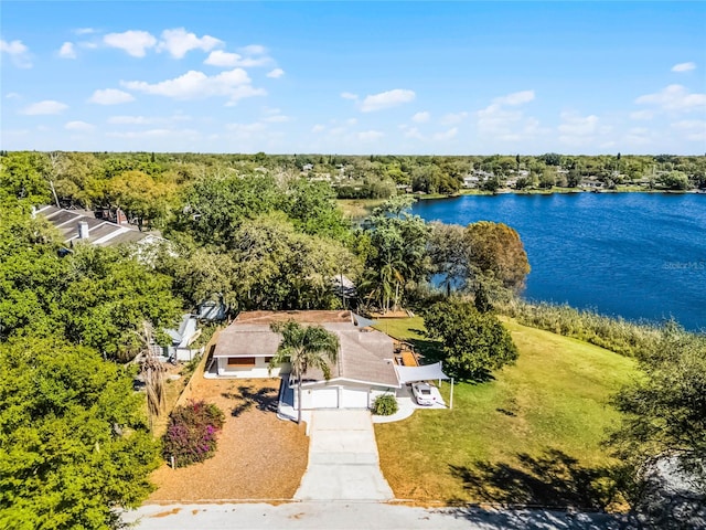 drone / aerial view featuring a view of trees and a water view