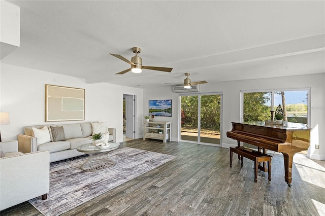 living room with a ceiling fan, wood finished floors, baseboards, and a wall mounted air conditioner