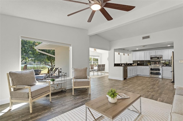 living room featuring visible vents, a ceiling fan, lofted ceiling with beams, dark wood-style floors, and baseboards