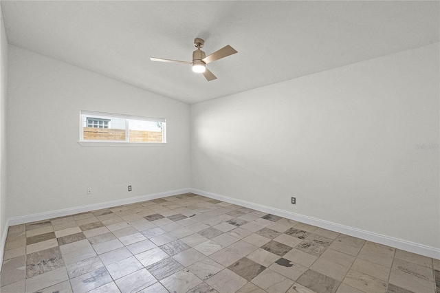 spare room featuring baseboards, a ceiling fan, and vaulted ceiling