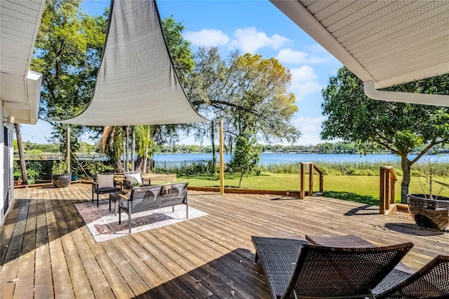 wooden deck with a yard and a water view