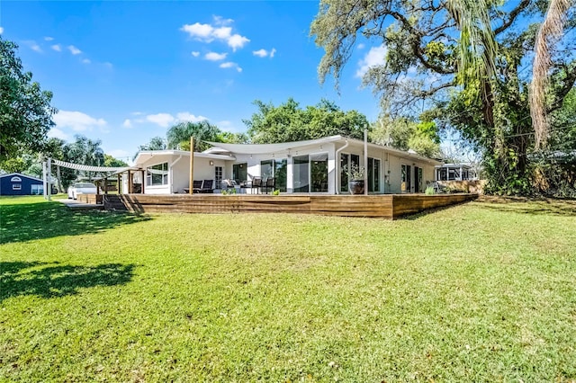 rear view of property featuring stucco siding and a yard