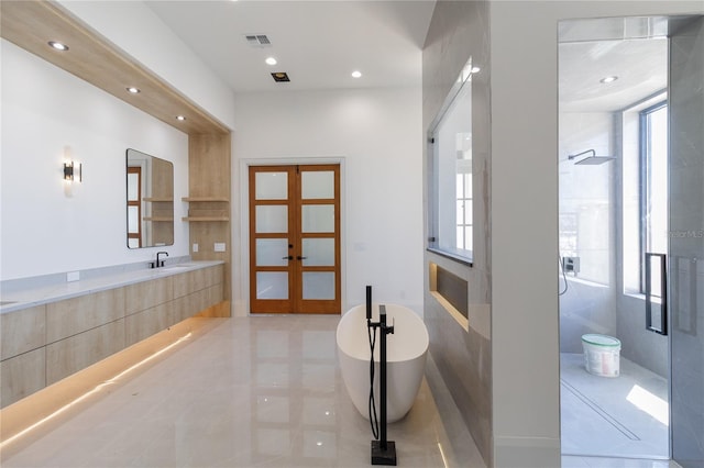 bathroom featuring visible vents, a stall shower, recessed lighting, a soaking tub, and vanity