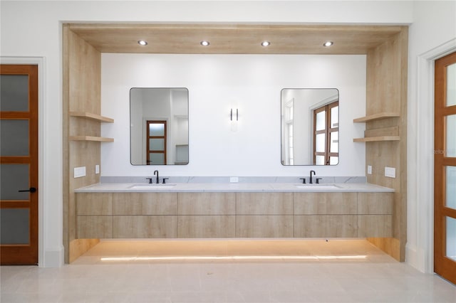 bathroom with double vanity, recessed lighting, and a sink