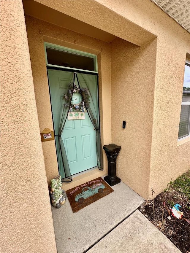 doorway to property with stucco siding