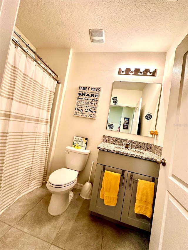 bathroom with visible vents, curtained shower, toilet, vanity, and a textured ceiling