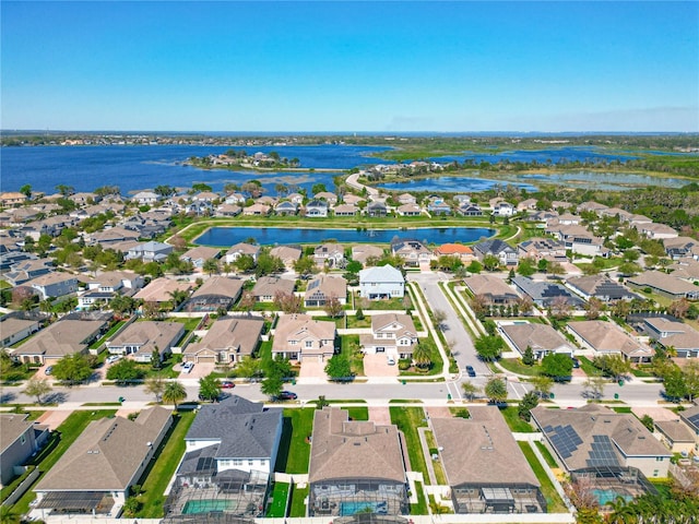 drone / aerial view with a residential view and a water view