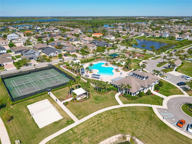 drone / aerial view with a residential view and a water view