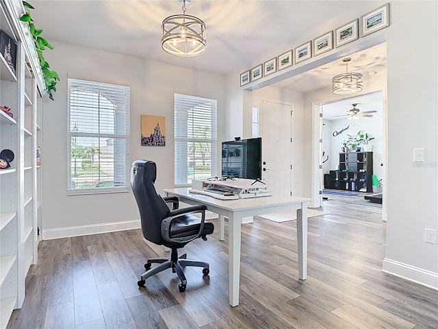 office area with baseboards and wood finished floors