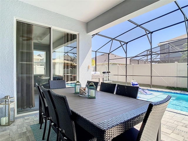 view of patio with glass enclosure, outdoor dining area, a fenced in pool, and fence