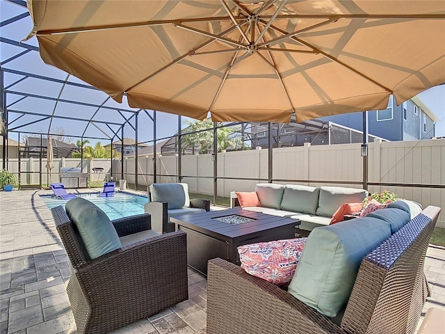 view of patio / terrace featuring an outdoor living space with a fire pit, a lanai, a fenced backyard, and a fenced in pool