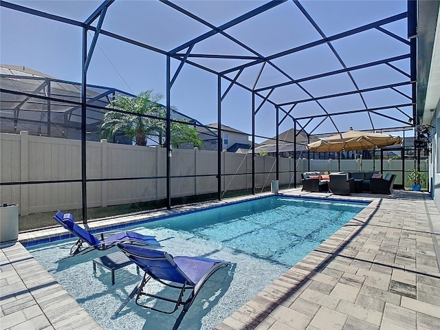 view of pool with a lanai, a fenced backyard, outdoor lounge area, and a patio area