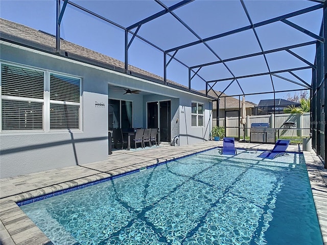 view of pool with a fenced in pool, fence, ceiling fan, a lanai, and a patio area